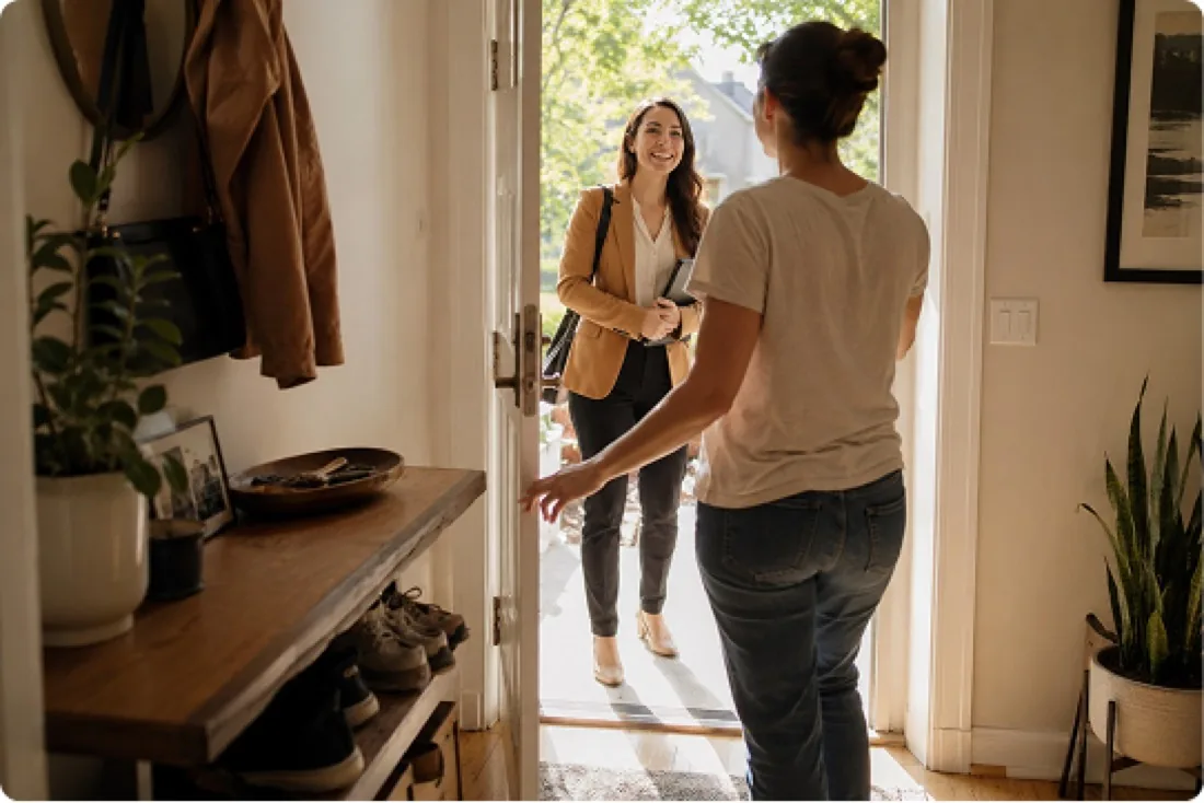 An agent being welcomed at a seller's front door